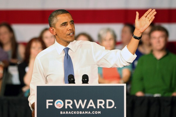 President Barack Obama gives a speech in Florida. The podium displays his grammatically controversial campaign slogan, 